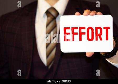 A businessman holding a business card with the words, It's All In Your Hands, written on it. Stock Photo