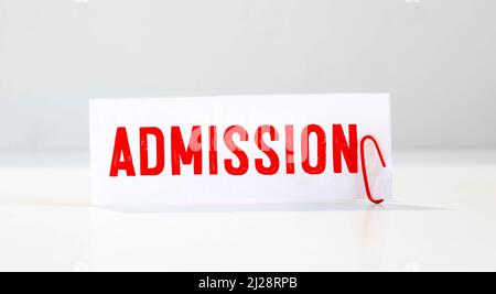 ADMISSIONS of the word on paper. concept. Words of ADMISSIONS on a wooden background Stock Photo