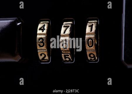 Combination code lock, three numbers numerical password suitcase lock mechanism, object detail, macro, extreme closeup, private belongings safety, sec Stock Photo