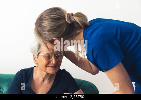 Young caregiver woman supporting her elderly grandmother. . High quality photo Stock Photo