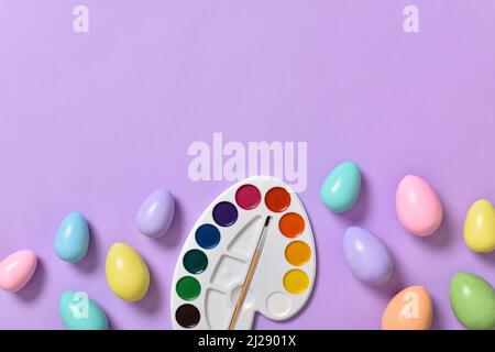 Easter background with painted eggs, and paints. Space for copying. Flat position, top view Stock Photo