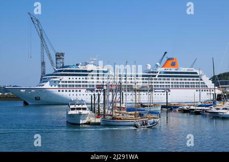 Luxury cruise ship docked in Falmouth Harbour dwarfing the sailing boats in Port Pendennis Marina, Falmouth, Cornwall, England, UK Stock Photo