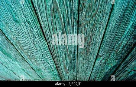Long stripes on a green wooden wall with wood texture and beige peeling paint Stock Photo
