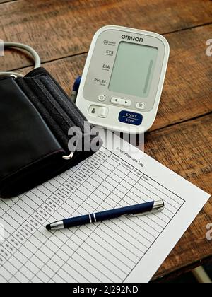 Sphygmomanometer or blood pressure monitor, cuff, and chart ready to monitor heart health.  Concept of healthy lifestyle. Stock Photo