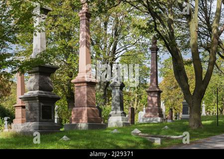 Gravestones in Notre Dame des Neiges cemetery on Mount Royal in early autumn, Montreal, Quebec, Canada. Stock Photo