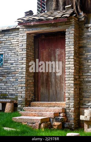 Close-up of wooden door of brick house in ancient Chinese architecture Stock Photo