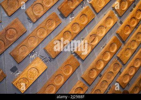 Wall full of Chinese moon cake moulds hanging on the wall Stock Photo