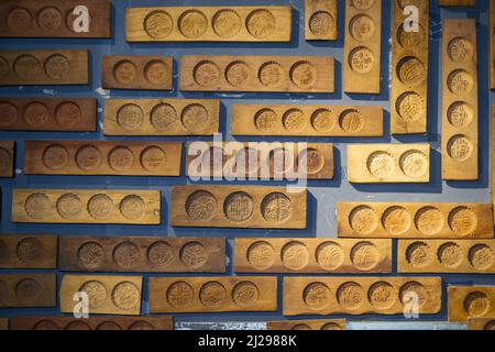 Wall full of Chinese moon cake moulds hanging on the wall Stock Photo