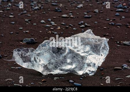 Melted iceberg, ice crystal and pebbles on black lava beach, Diamond Beach, Joekulsarlon, Vatnajoekull National Park, Southeast Iceland, Iceland Stock Photo