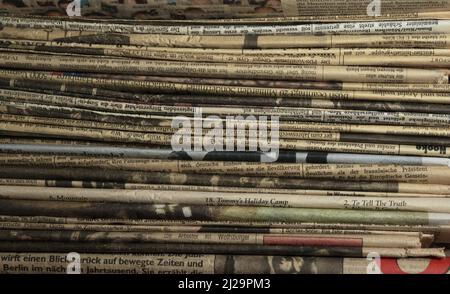 A stack of old, partly already yellowed newspapers Stock Photo