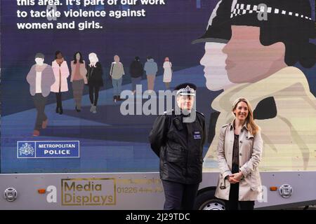 Superintendent Andy Brittain (left) and detective superintendent Brittany Clarke (right), who is from the Violent Crime Task Force, posing in front of a women's safety advert from The Metropolitan Police as part of Operation Verona. The operation is led by Metropolitan Police's Violent Crime Taskforce, where officers use information provided by women via the Street Safe app to target violence against women and girls. Picture date: Friday March 25, 2022. Stock Photo