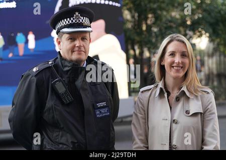 Superintendent Andy Brittain (left) and detective superintendent Brittany Clarke (right), who is from the Violent Crime Task Force, posing in front of a women's safety advert from The Metropolitan Police as part of Operation Verona. The operation is led by Metropolitan Police's Violent Crime Taskforce, where officers use information provided by women via the Street Safe app to target violence against women and girls. Picture date: Friday March 25, 2022. Stock Photo