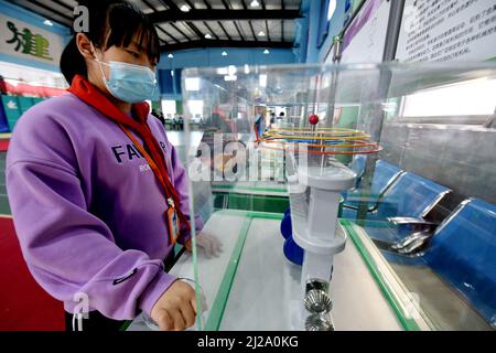 ZHANGJIAKOU, CHINA - MARCH 31, 2022 - A primary school student experiences the charm of technology at the China Mobile Science and Technology Museum i Stock Photo