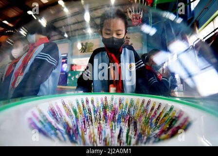 ZHANGJIAKOU, CHINA - MARCH 31, 2022 - A primary school student experiences the charm of technology at the China Mobile Science and Technology Museum i Stock Photo