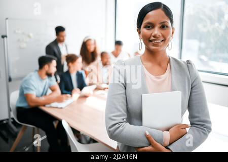 This is where we come up with all our winning ideas. Cropped portrait of an attractive young businesswoman attending a meeting in the boardroom with Stock Photo