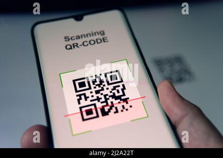 Close-up Of Businessman Scanning A Barcode Using Cell Phone Stock Photo