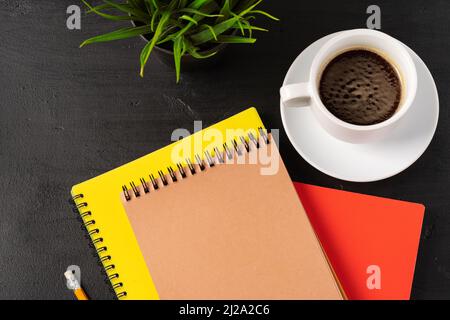 Three notepads on a black table close up Stock Photo