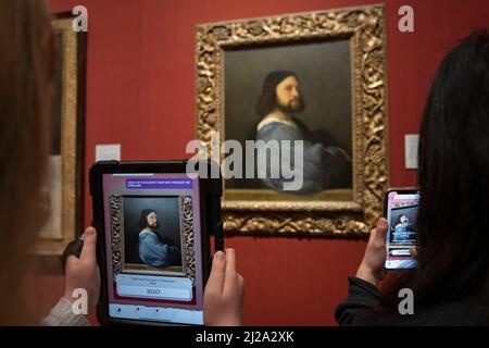 (Embargoed until 09.30am BST, Thursday 31st March 2022). The National Gallery, Trafalgar Square, London, UK. 31 March 2022. The National Gallery launches its first immersive augmented reality app created with the help of over 70 children in time for the Easter holidays. The Keeper of Paintings and the Palette of Perception is a free mobile-based experience, available on phones and tablets, that uses AR technology encouraging children to explore the Gallery and learn about its paintings. (children in image all model-released by the Gallery for Editorial use). Credit: Malcolm Park/Alamy Live New Stock Photo