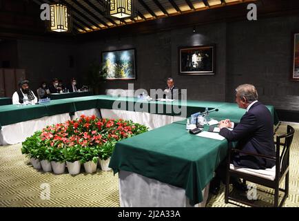 Hefei, China's Anhui Province. 30th Mar, 2022. Chinese State Councilor and Foreign Minister Wang Yi presides over the meeting of foreign ministers of China, Afghanistan and Pakistan in Tunxi, east China's Anhui Province, March 30, 2022. Pakistani Foreign Minister Shah Mahmood Qureshi and acting Foreign Minister of the Afghan Interim Government Amir Khan Muttaqi attended the meeting. Credit: Zhou Mu/Xinhua/Alamy Live News Stock Photo