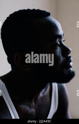 Thoughtful bearded man with looking away at home Stock Photo