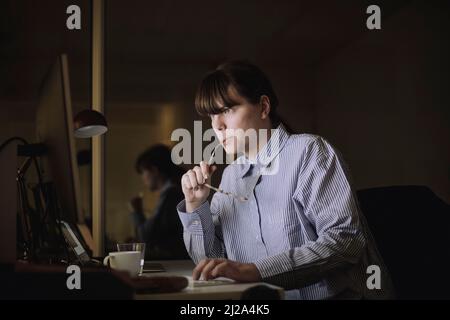 Young businesswoman using computer while working at work place Stock Photo