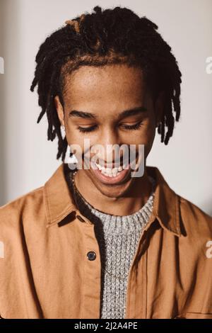 Happy young man looking down over white background Stock Photo