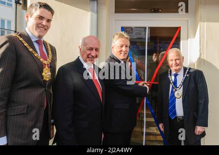 12/10/2012, Belfast - First Minister Peter Robinson [3rd left] cuts the ribbon at the opening of Robin Newtown's [2nd left] new constituency office in Belfast.  With Lord Mayor of Belfast, Gavin Robinson [L] and Deputy Mayor of Castlereagh, Tommy Sandford [R] Stock Photo