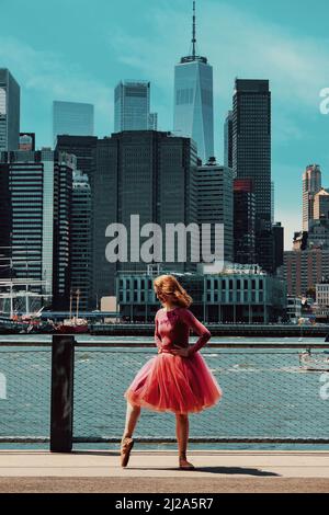 ginger beautiful female model dancing ballet on street, downtown Brooklyn, New York City financial district cityscape ballet tutu Stock Photo