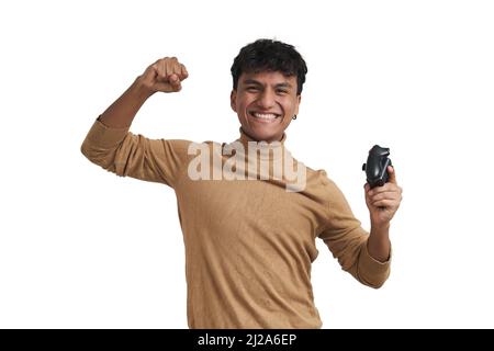 Young peruvian man playing video games with a joystick, isolated. Stock Photo