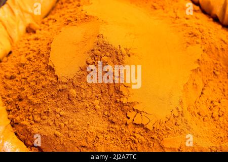 Turmeric powder on a sack close up shot with selective focus Stock Photo