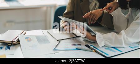 Group of business people busy discussing financial matter during meeting. Corporate Organization Meeting Concept Stock Photo