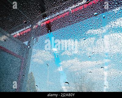 Water drops on car windscreen in car wash self-service, selective focus Stock Photo