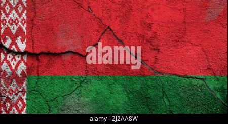 Full frame photo of a weathered flag of Belarus painted on a cracked wall. Stock Photo
