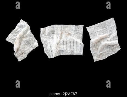 Set with three used crumpled wet wipes or napkins isolated on black Stock Photo