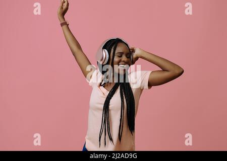 Beautiful young woman dancing and listening music in headphones chill out sounds Stock Photo