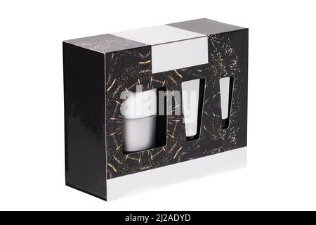 Closeup of a decorative black cosmetic box or gift box with label-free white tubes and containers isolated on a white background. Macro. Stock Photo