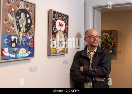 Edinburgh, United Kingdom. 31 March, 2022 Pictured: Artist Colin Brown with his works (L to R) Dalmation Iris (2021) and Red Lily (2021). Colin Brown is a mixed media artist and painter based in the North East of Scotland. This new exhibition, Primavera, pays homage to the 18th century Belgian flower painter Pierre-Joseph Redouté.  The exhibition is at the Scottish Gallery in Edinburgh from 31 March 2022 to 30 April 2022. Credit: Rich Dyson/Alamy Live News Stock Photo