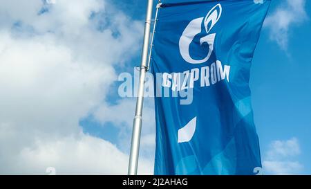 Cacak, Serbia - March 10, 2022: Gazprom flag waving in wind on gas station in Serbia. Gazprom is multinational energy corporation headquartered in Sai Stock Photo