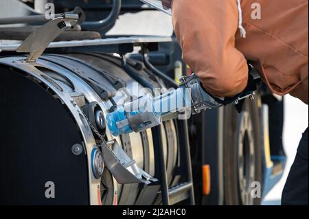 The tank gun for LNG gas is connected to the tank of the truck Stock Photo