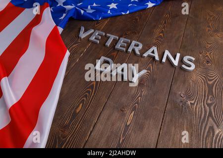 The Words Veterans Day Laid With Silver Metal Letters On Wooden Board 