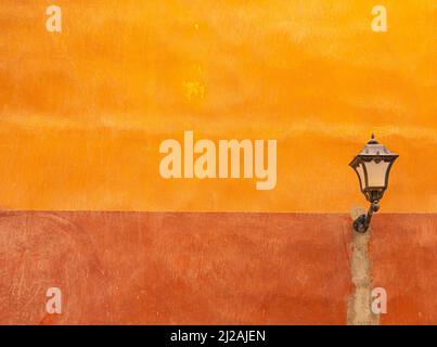 Old street lantern on orange Stock Photo