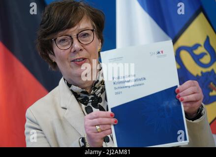 Kiel, Germany. 31st Mar, 2022. Sabine Sütterlin-Waack (CDU), Minister of the Interior, Rural Areas, Integration and Equality in Schleswig-Holstein, holds up the Schleswig-Holstein Police Crime Statistics 2021 after a press conference. Credit: Marcus Brandt/dpa/Alamy Live News Stock Photo