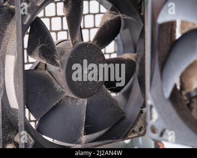 A dusty fan in a computer case. Close up. Stock Photo