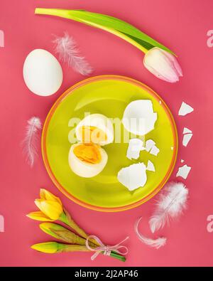 Beautiful spring nature background with eggs, blossom and feather a on pink background Stock Photo