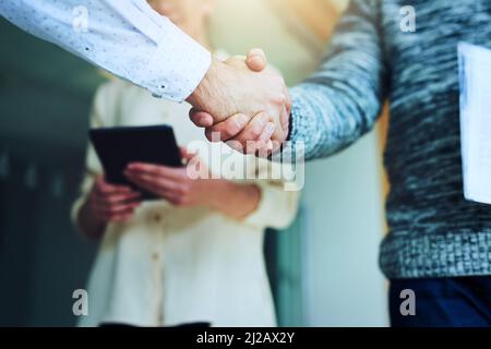 Partnering together to take over the business world. Closeup shot of unrecognizable businesspeople shaking hands in an office. Stock Photo
