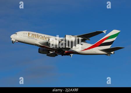 An Airbus A380 operated by Emirates departs from London Heathrow Airport Stock Photo