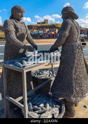 Wire statue of a fishwife at the harbor in the port of Whitby on the North Yorkshire coast in the northeast of England. Stock Photo