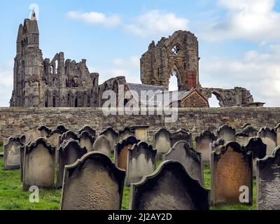 View of the ruins of Whitby Abbey from the graveyard of the Church of Saint Mary, an Anglican parish church in the coastal town of Whitby in North Yor Stock Photo