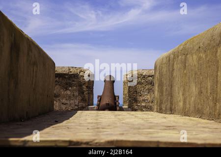 Ancient canon pointing out at the open sea from ancient Asila Fort, Morocco, North Africa Stock Photo