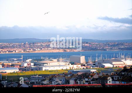 Isle of Portland. 31st March 2022. UK Weather. First light catches yacht masts in Portland harbour. Credit: stuart fretwell/Alamy Live News Stock Photo